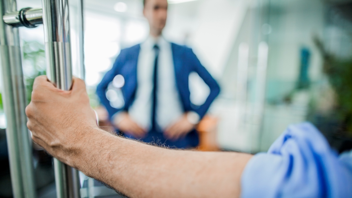 Hand opening door to businessman