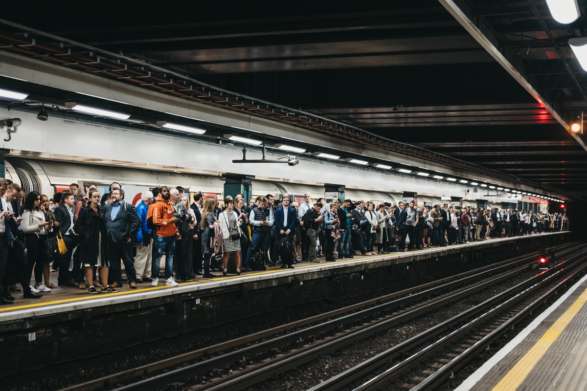 Large group of people on a platform of Moorgate station, London Undeground, UK.