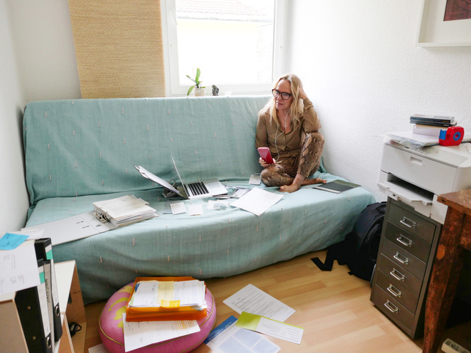 Woman Working From Home on Her Couch with Laptop