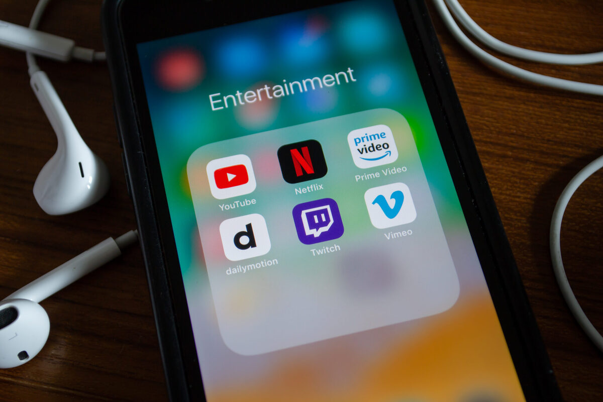 iPhone 7 showing its screen with YouTube, Netflix and other video streaming applications.